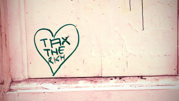 A door with "tax the rich" written in a heart. 
