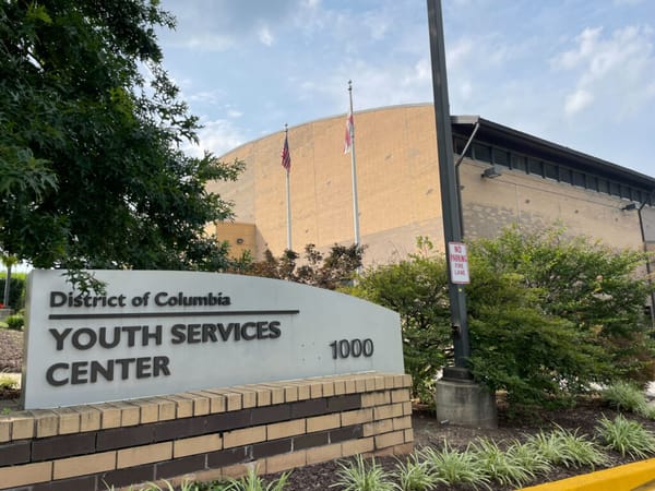 A picture of a building with a sign that reads "District of Columbia Youth Services Center"