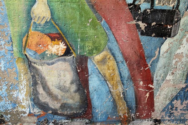  chipped mural of people carrying grocery bags. 